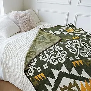 Detailed view of woven ethnic blanket with geometric pattern for cozy home decor and warmth.