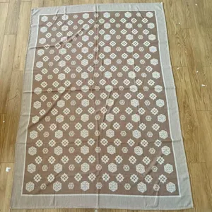 Detailed view of the soft throw blanket featuring an elegant clover pattern and fine texture.