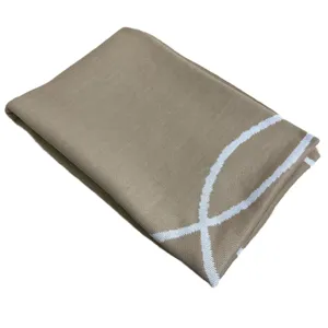 Khaki knitted jacquard blanket with white pattern, soft cotton throw for home and office use.