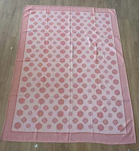 Detail view of pink clover pattern knit summer throw blanket, soft nap air conditioning quilt.