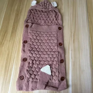 Baby knitted sleeping bag detail, pink infant anti kick blanket with cute ears and tail.