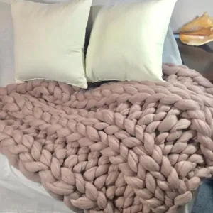 Cozy chunky knit blanket for home decor, soft handmade wool throw blanket for bed or sofa.