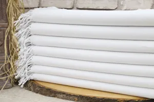White Turkish beach towel with fringe, premium woven peshtemal bath towel for home and travel use.