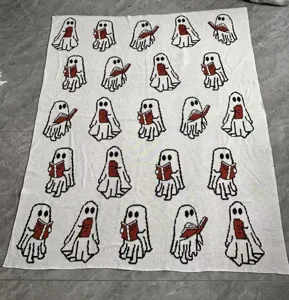 Cozy knit throw blanket featuring cute reading ghost pattern for sofa and bedroom decor.