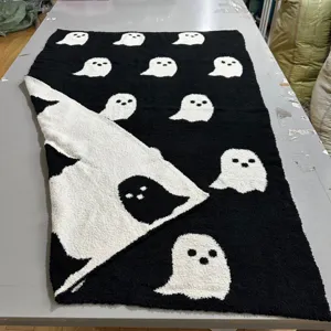 Black and white ghost patterned throw blanket, soft plush knitted blanket for home decor.