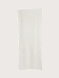Cozy knit throw blanket in soft cream plush fabric, offering warm comfort for sofa and bed use.