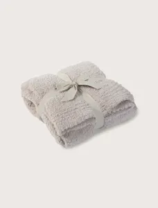 Cozy plush throw blanket detail folded with ribbon bow soft winter warm cozy home decor sofa