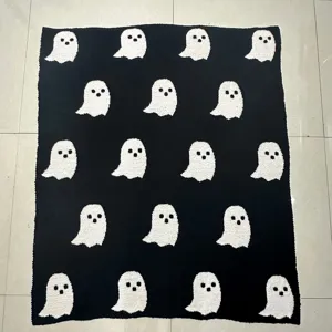 Cozy black knitted throw blanket featuring white ghost pattern, soft fleece for bed sofa.