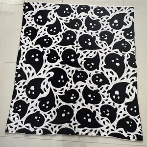 Black and white cute ghost pattern knitted throw blanket for cozy bedroom home decor styling.