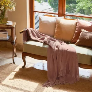 Pink knitted throw blanket with fringe for sofa bed living room cozy home decor style