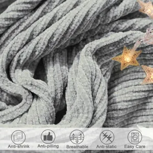 Grey ribbed knitted throw blanket closeup showing soft plush texture and cozy design features.