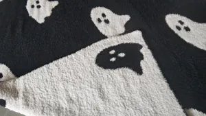 Close-up view showing the soft fluffy texture and ghost pattern detail of the blanket.