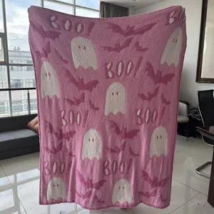 Pink plush fleece blanket detail featuring cute white ghost and bat jacquard patterns for autumn.