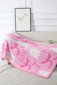 Pink ghost knit throw blanket detail showing soft textured fabric and cute Halloween patterns.