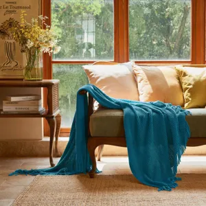 Blue knitted sofa throw blanket with fringe, cozy waffle knit texture for living room decor