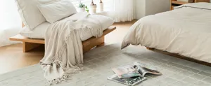 Beige knitted throw blanket with tassels for sofa or bed cozy soft home warmth decor.