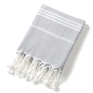 Telo mare turco jacquard a losanghe con frange, morbida struttura in cotone, coperta grigia.