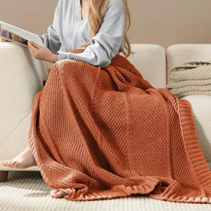 Cozy knitted throw blanket with diagonal stripe design, soft sofa cover for living room.