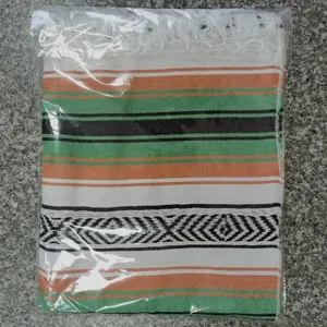 Woven Mexican blanket with geometric stripes and fringe, ideal for beach, picnic, yoga mat.