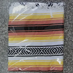 Woven Mexican blanket with colorful stripes and fringe, perfect for beach, picnic, or yoga.