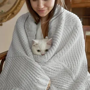 Cozy knitted throw blanket detail showing soft grey texture, ideal for sofa and bedroom use.