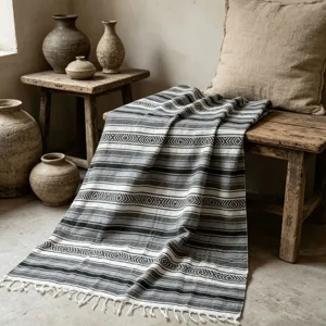 Woven Mexican blanket with geometric stripes and fringe, perfect throw blanket for sofa, bed or picnic.
