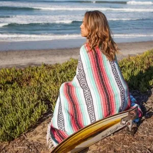 Woven Mexican blanket detail view, colorful diamond jacquard outdoor beach and picnic blanket.
