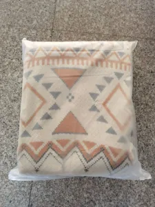 Boho knitted throw blanket detail view, geometric pattern blanket for sofa or camping.