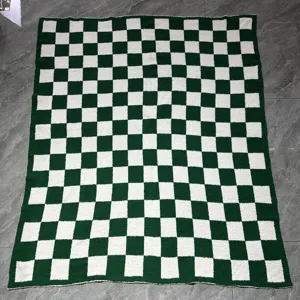Green and white checkered plush knit throw blanket detail view for cozy home decor.
