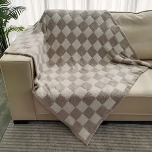 Cozy brown and white checkered throw blanket detail view showcasing soft flannel texture.