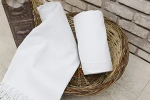 White woven beach towel with elegant tassels, perfect for quick drying and embroidery.
