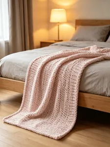 Cozy pink chunky knit blanket scene showing soft texture and home decor styling details.
