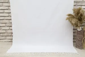 White Turkish beach towel with fringe, woven lightweight bath towel for summer travel use.