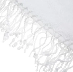 Close-up detail of white Turkish beach towel with elegant knotted fringe and soft woven texture.