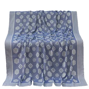 Blue woven summer cooling blanket throw with traditional floral pattern for travel use