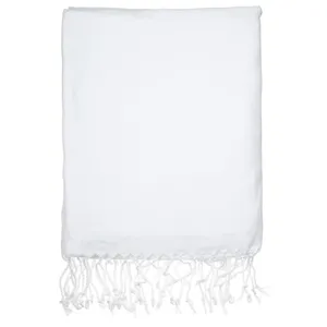 White Turkish beach towel close-up, woven fabric detail with delicate bottom fringe tassels.