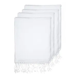 Detail view of white Turkish beach towels stacked neatly with classic woven fringe edges.