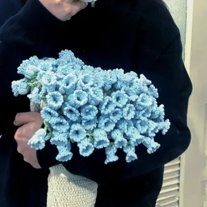 Handmade blue crochet flower bouquet detail shot, exquisite crochet craft knit decor.