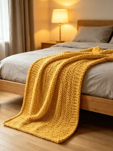 Chunky knit blanket detail, cozy yellow chenille yarn throw for sofa and bed, thick handmade look.