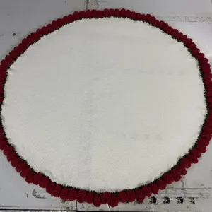 Round knitted blanket with red rose flower border, cozy white crochet throw for kids nap bed.