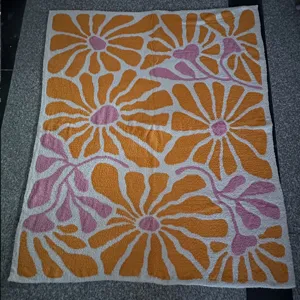 Retro floral pattern soft fleece blanket detail, cozy sofa throw for home living decor.