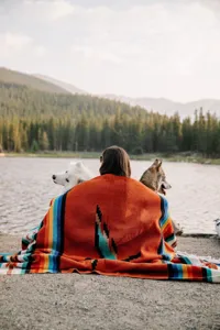 Cozy woven southwestern style throw blanket with colorful thunderbird pattern for outdoor camping.