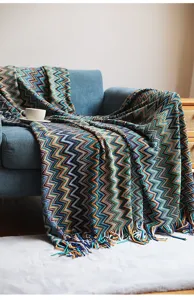 Bohemian woven throw blanket with fringe, colorful chevron knit sofa cover for home decor.