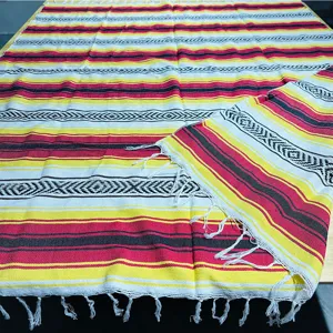 Woven Mexican blanket multi-color striped outdoor picnic blanket with fringe and jacquard design.