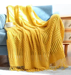 Cozy yellow knitted throw blanket detail, textured home decor couch blanket with fringe.
