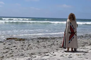 Woven jacquard beach blanket with Navajo Thunderbird Aztec pattern for outdoor use.