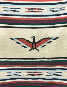 Close-up detail of the woven Aztec style blanket featuring traditional tribal bird and stripe patterns.