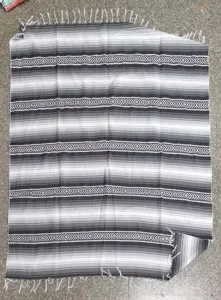 Woven Mexican blanket with geometric diamond pattern and striped design for outdoor beach and picnic.
