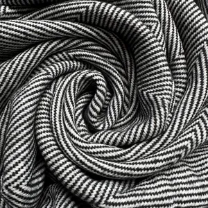 Black and white herringbone knit throw blanket detail, cozy woven acrylic blanket fabric texture
