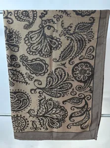 Vue détaillée de la couverture tissée jacquard avec un motif cachemire marron classique.